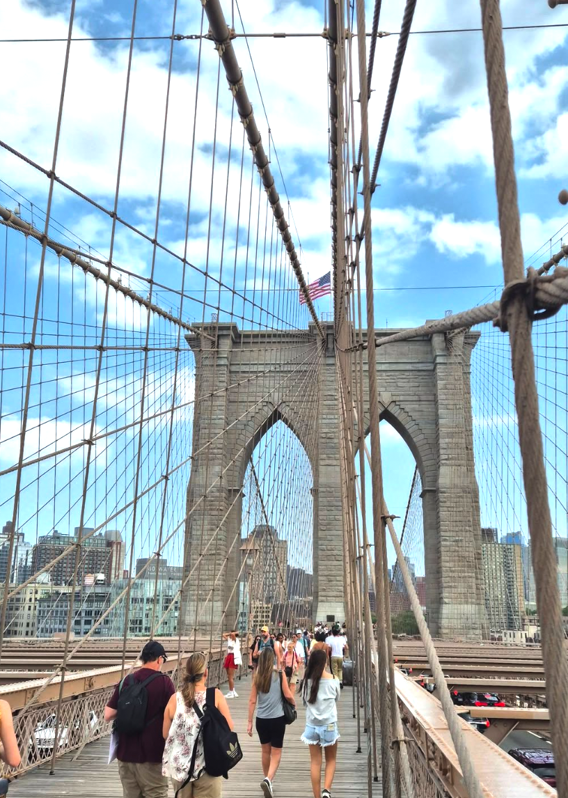 A guided walking group crossing the Brooklyn Bridge